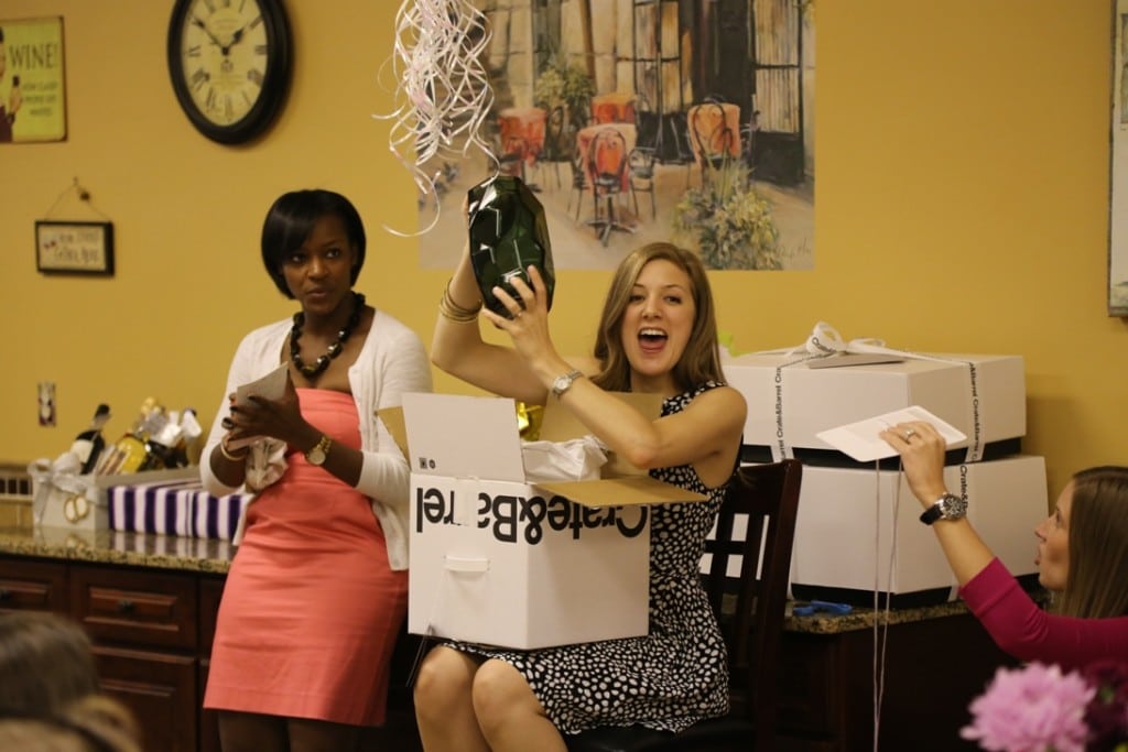 image of very happy bride opening gifts at her winery bridal shower at your own winery