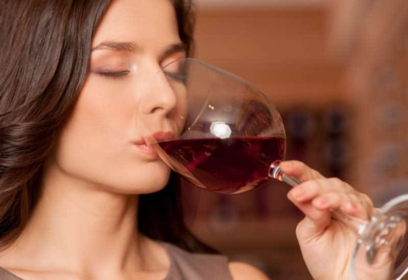 image of a woman taking a sip of wine for the 4th S of wine tasting the Sip at your own winery